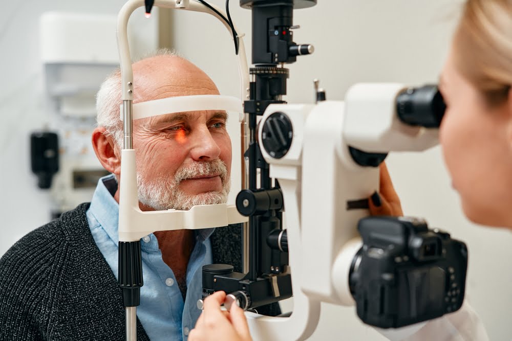 Eye exam of mature men consulting doctor for eyesight at optometrist - Eye Exam in Queens, NY Eye exam of mature men consulting doctor for eyesight at optometrist - Eye Exam in Queens, NY