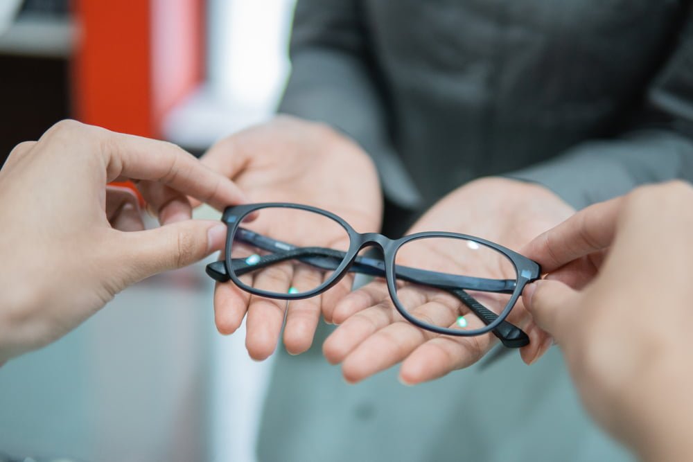 Person handing over glasses - Eyeglasses in Rockaway Park, NY