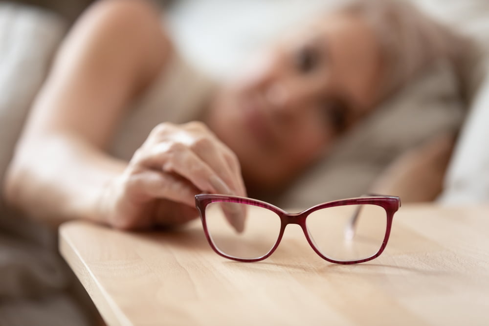 woman holding taking optical glasses - Eyeglasses in Rockaway Park, NY